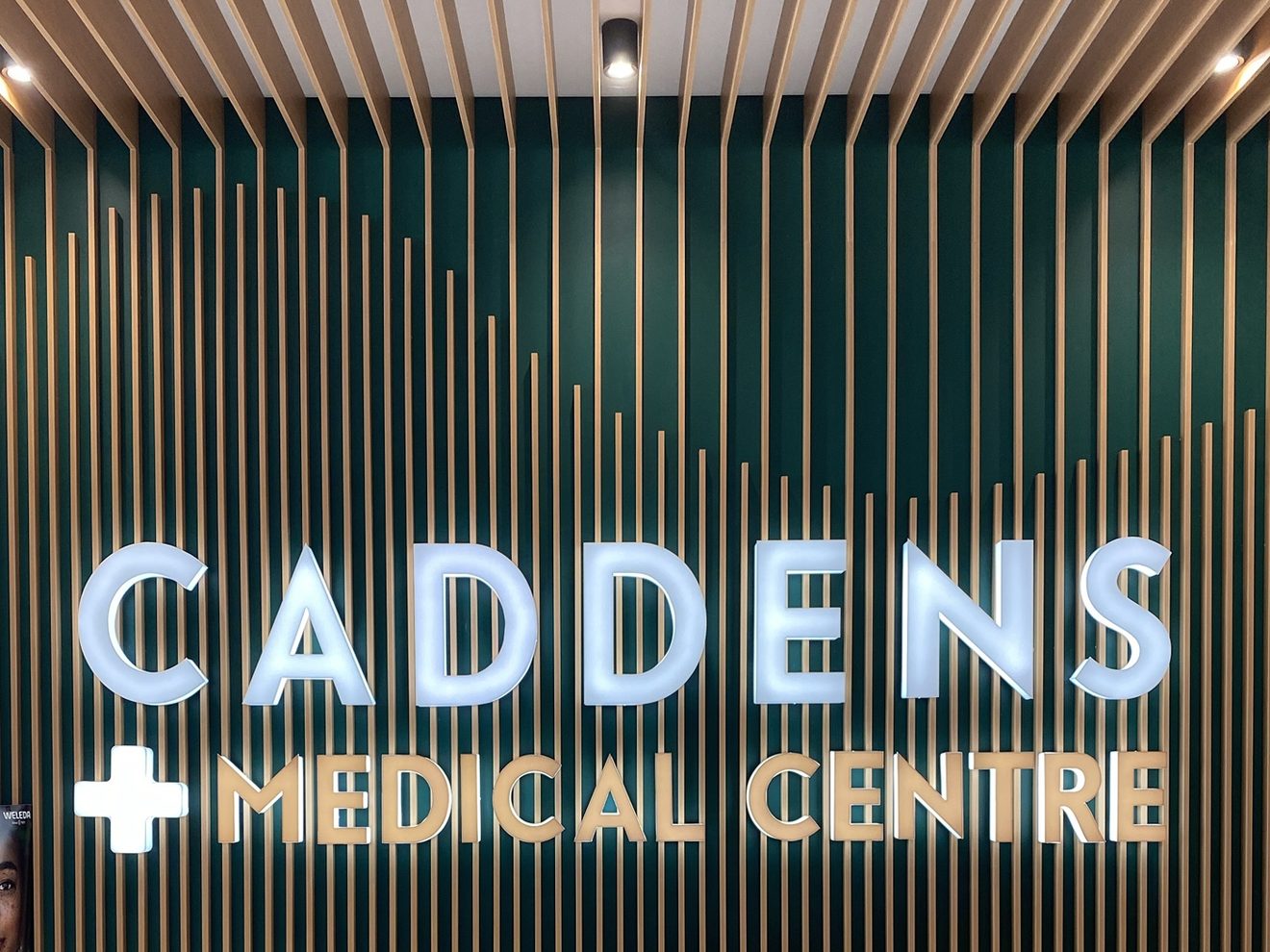 Caddens Medical Centre sign on the green and timber reception wall
