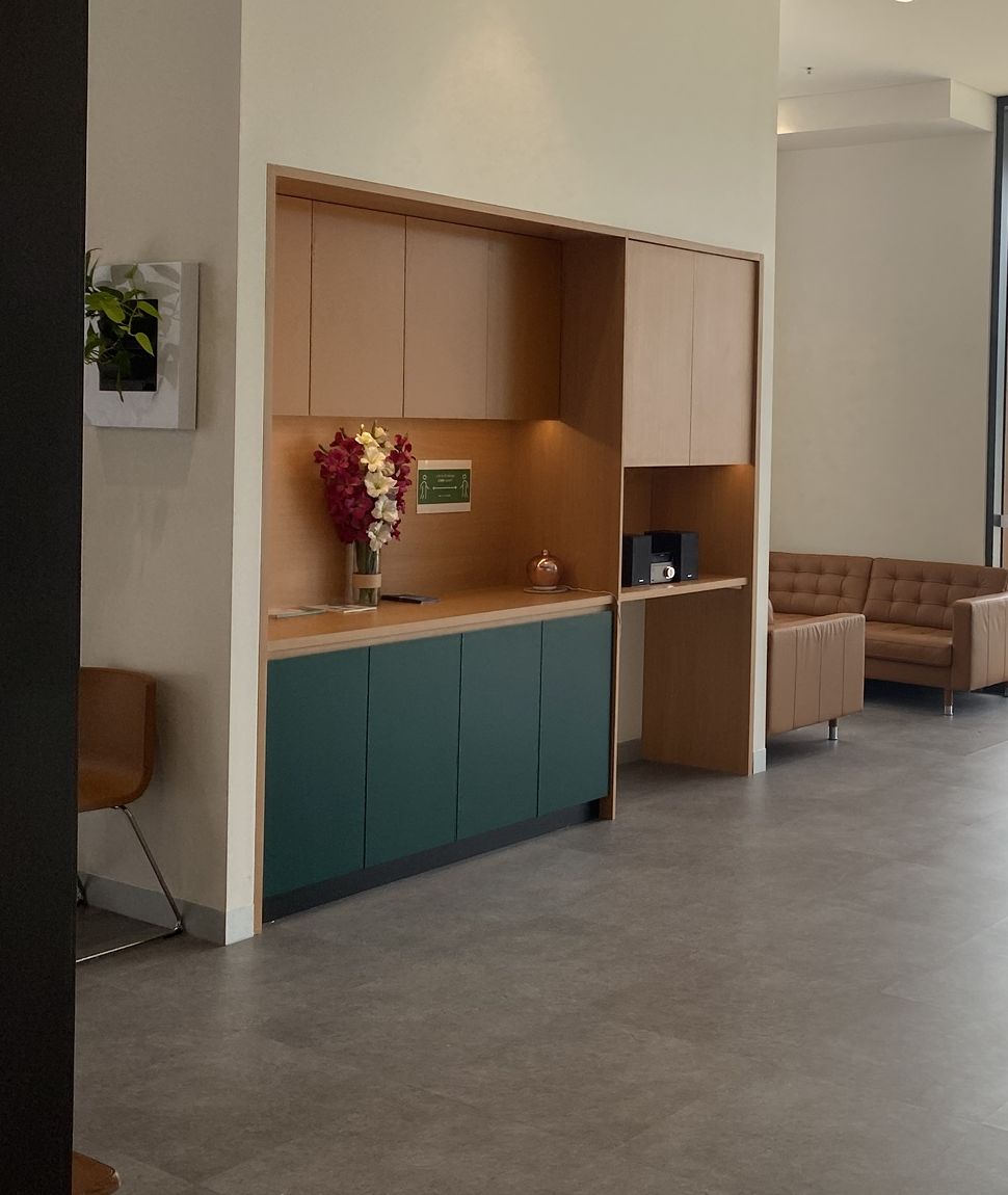 Waiting area with timber cabinetry and leather lounges